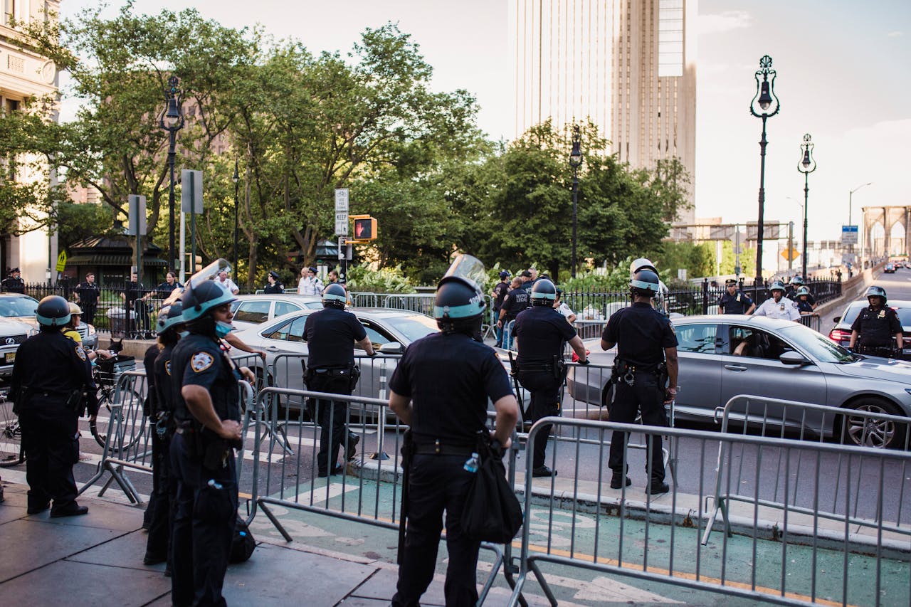 Law enforcement officers manage traffic and crowd control in urban city setting.