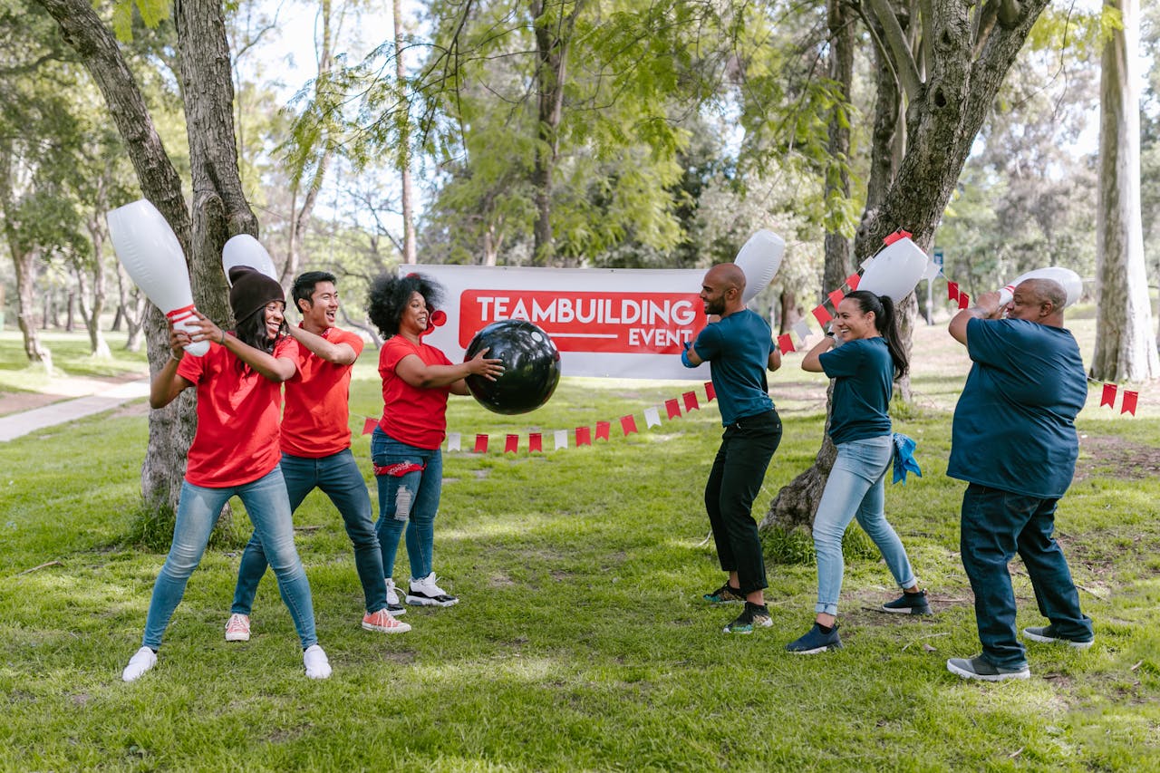 Dynamic outdoor team building activity with diverse group playing in the park.